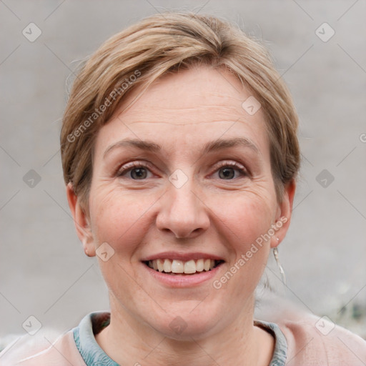 Joyful white adult female with short  brown hair and grey eyes