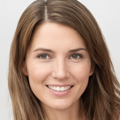 Joyful white young-adult female with long  brown hair and brown eyes