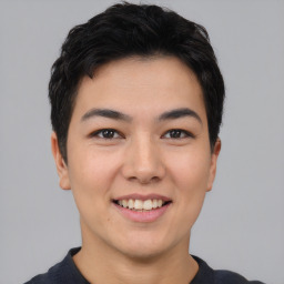 Joyful asian young-adult male with short  black hair and brown eyes