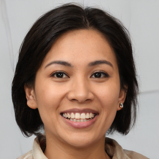 Joyful asian young-adult female with medium  brown hair and brown eyes