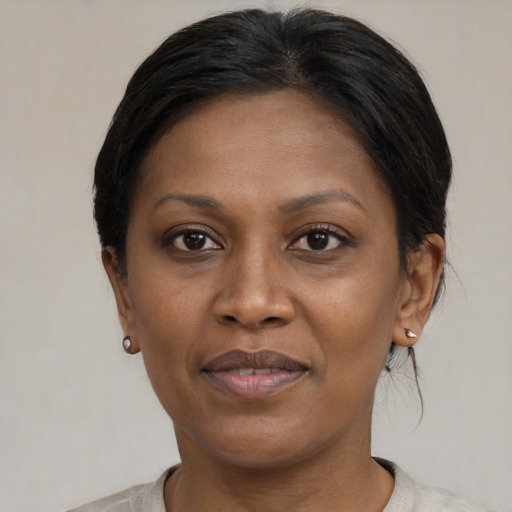 Joyful black adult female with short  brown hair and brown eyes