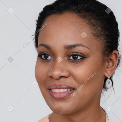 Joyful black young-adult female with long  brown hair and brown eyes