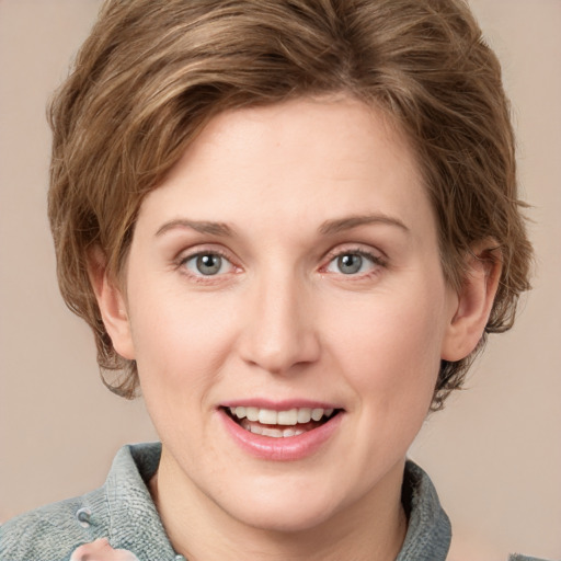 Joyful white young-adult female with medium  brown hair and blue eyes