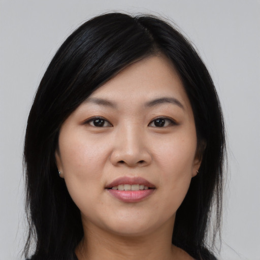 Joyful asian young-adult female with long  black hair and brown eyes