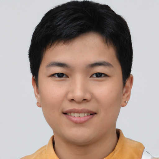 Joyful asian young-adult male with short  black hair and brown eyes