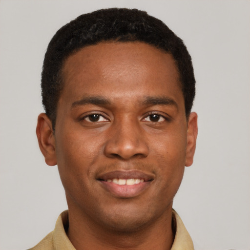 Joyful black young-adult male with short  brown hair and brown eyes