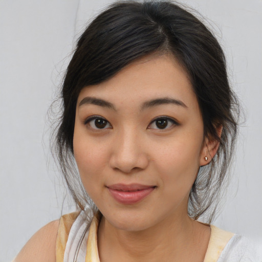 Joyful asian young-adult female with medium  brown hair and brown eyes