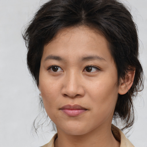 Joyful asian young-adult female with medium  brown hair and brown eyes