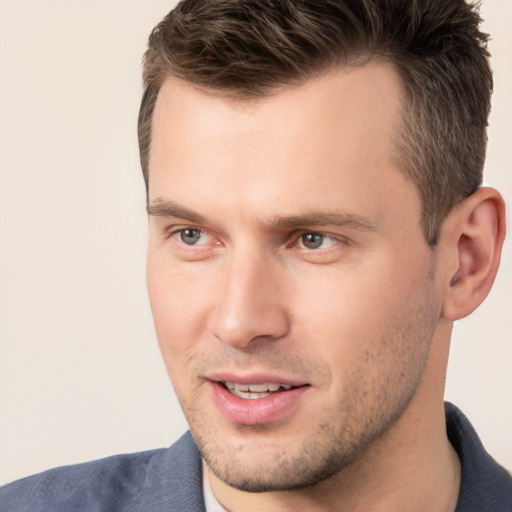 Joyful white young-adult male with short  brown hair and brown eyes