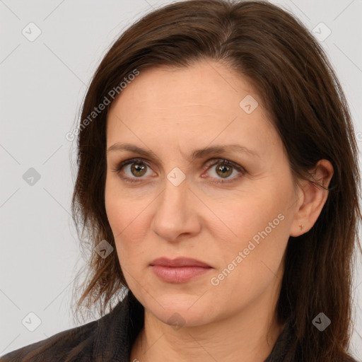 Joyful white adult female with long  brown hair and brown eyes