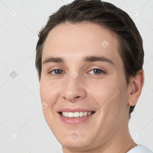 Joyful white young-adult female with short  brown hair and brown eyes