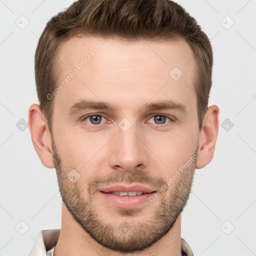 Joyful white young-adult male with short  brown hair and grey eyes