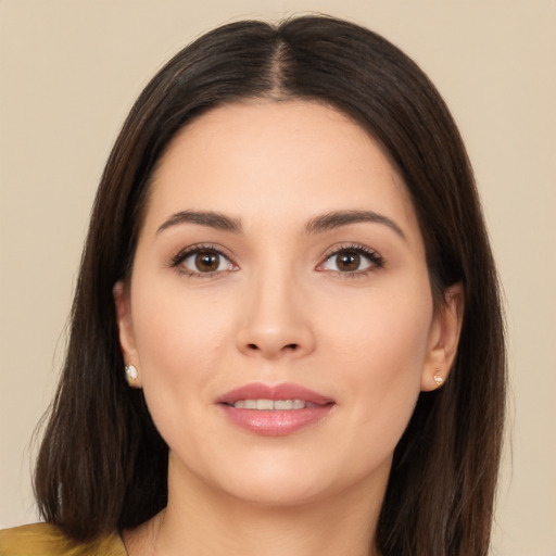 Joyful white young-adult female with long  brown hair and brown eyes