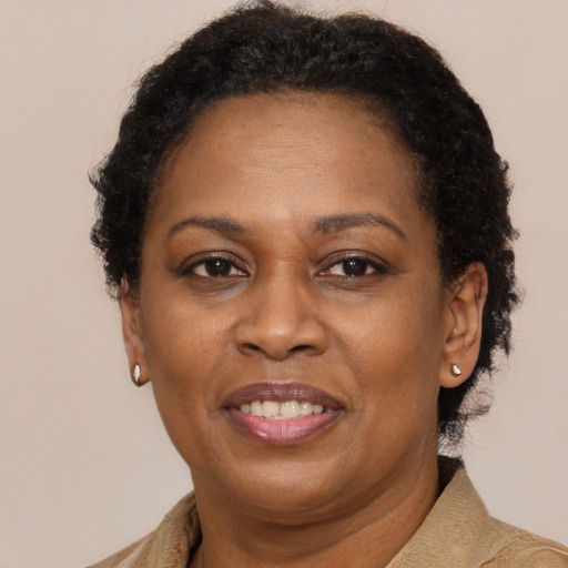 Joyful black adult female with short  brown hair and brown eyes