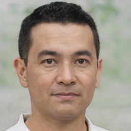 Joyful asian adult male with short  black hair and brown eyes