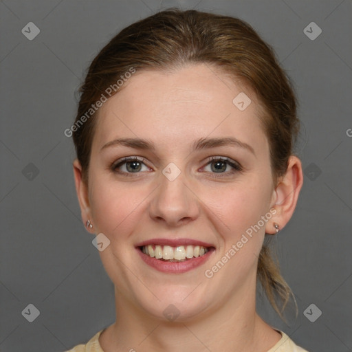 Joyful white young-adult female with medium  brown hair and grey eyes