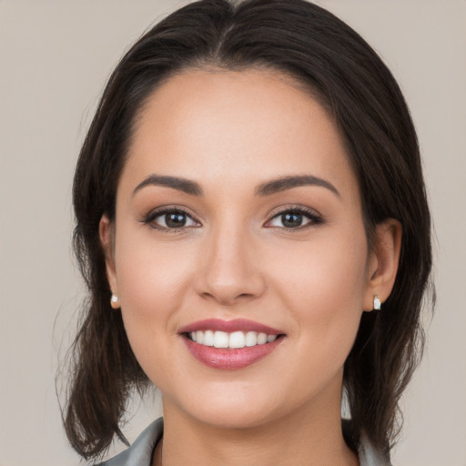 Joyful white young-adult female with medium  brown hair and brown eyes