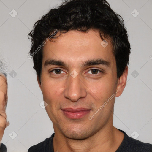 Joyful white young-adult male with short  black hair and brown eyes