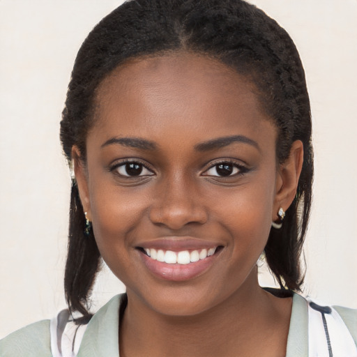 Joyful black young-adult female with long  brown hair and brown eyes