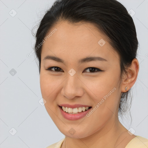 Joyful asian young-adult female with medium  brown hair and brown eyes