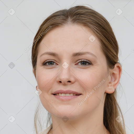 Joyful white young-adult female with long  brown hair and grey eyes