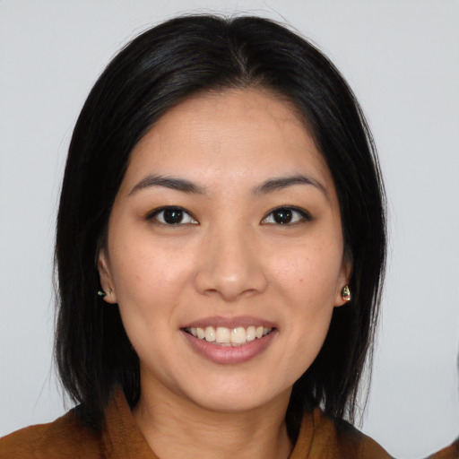 Joyful asian young-adult female with long  brown hair and brown eyes