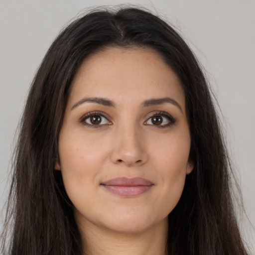 Joyful latino young-adult female with long  brown hair and brown eyes