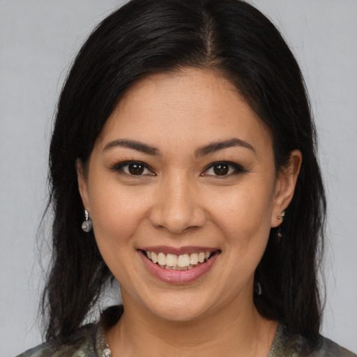 Joyful latino young-adult female with medium  brown hair and brown eyes