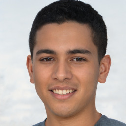 Joyful latino young-adult male with short  brown hair and brown eyes