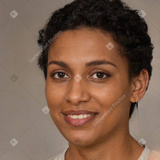 Joyful black young-adult female with short  brown hair and brown eyes