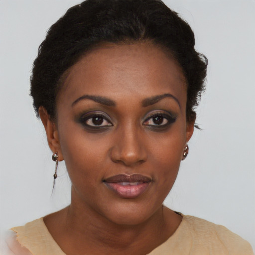 Joyful black young-adult female with short  brown hair and brown eyes