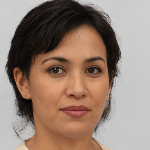 Joyful asian adult female with medium  brown hair and brown eyes