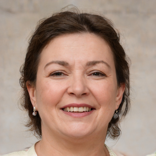 Joyful white adult female with medium  brown hair and brown eyes