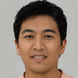 Joyful asian young-adult male with short  black hair and brown eyes