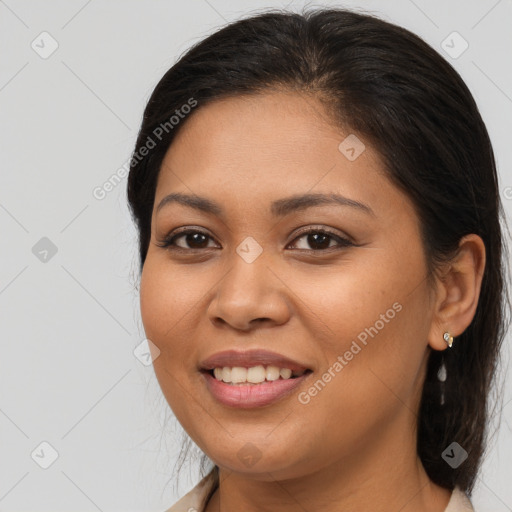 Joyful latino young-adult female with medium  brown hair and brown eyes