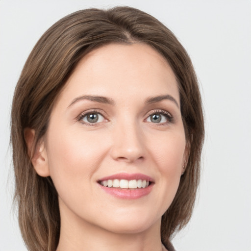 Joyful white young-adult female with medium  brown hair and grey eyes