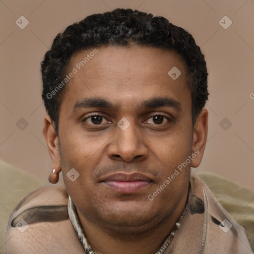 Joyful latino young-adult male with short  brown hair and brown eyes