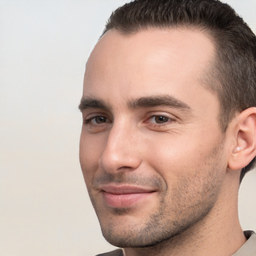 Joyful white young-adult male with short  brown hair and brown eyes