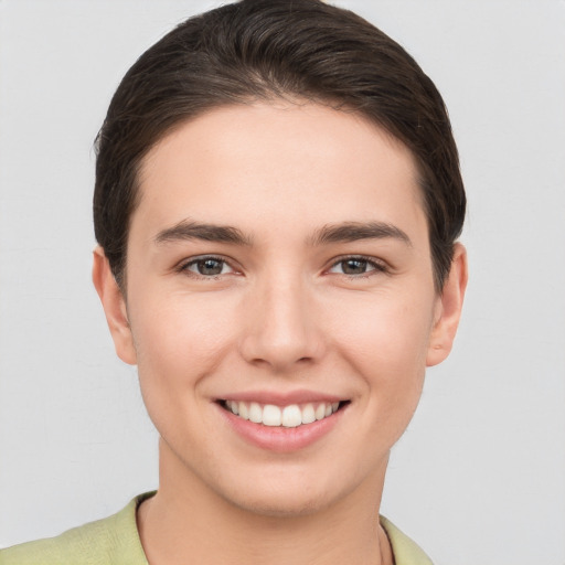 Joyful white young-adult female with short  brown hair and brown eyes