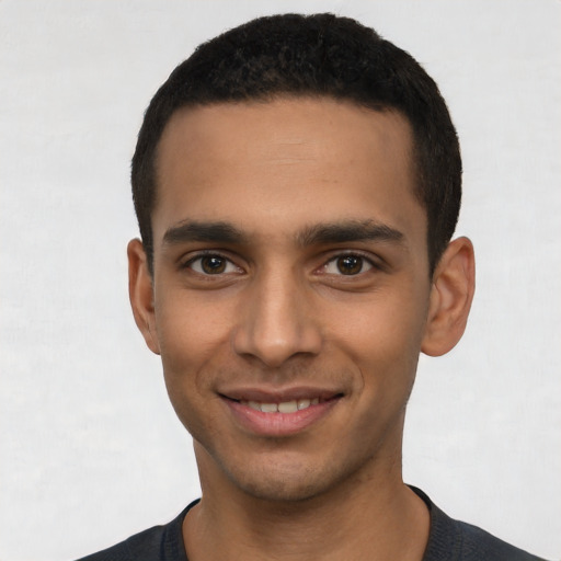 Joyful latino young-adult male with short  black hair and brown eyes