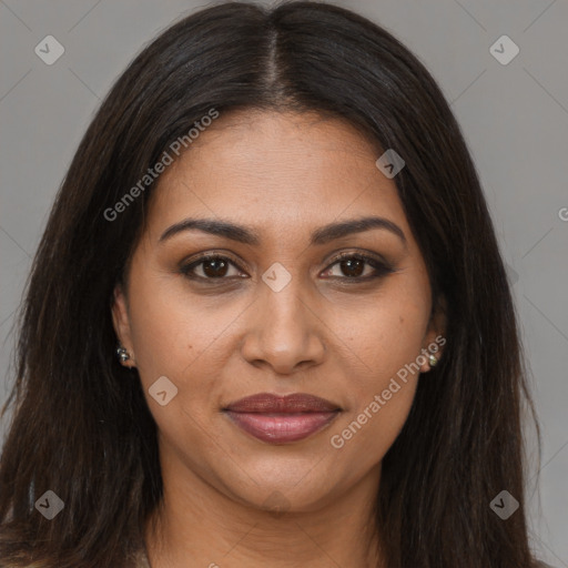 Joyful black young-adult female with long  brown hair and brown eyes