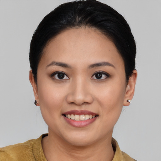 Joyful asian young-adult female with short  black hair and brown eyes