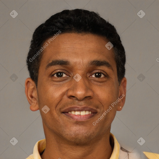 Joyful latino young-adult male with short  brown hair and brown eyes