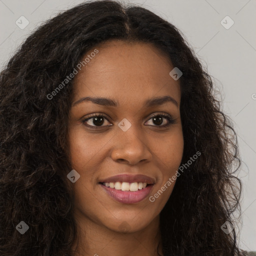 Joyful black young-adult female with long  brown hair and brown eyes