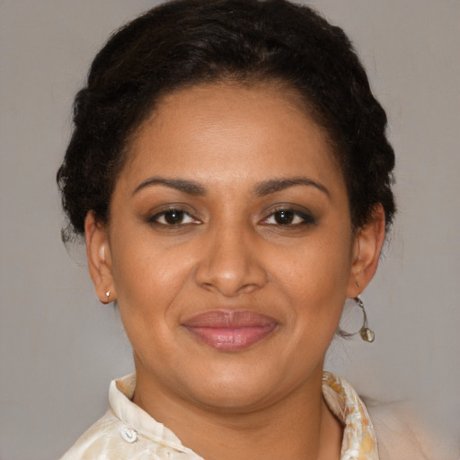 Joyful latino adult female with short  brown hair and brown eyes