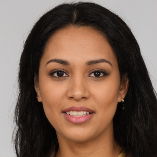 Joyful latino young-adult female with long  brown hair and brown eyes