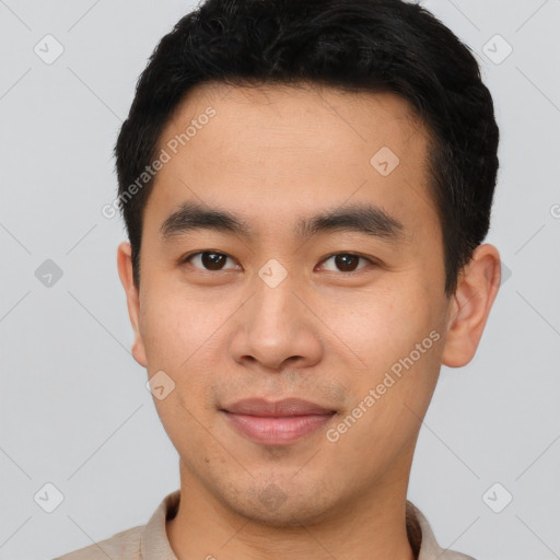 Joyful asian young-adult male with short  brown hair and brown eyes