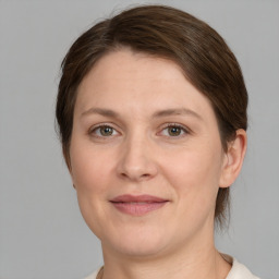 Joyful white adult female with medium  brown hair and grey eyes