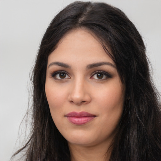 Joyful latino young-adult female with long  black hair and brown eyes