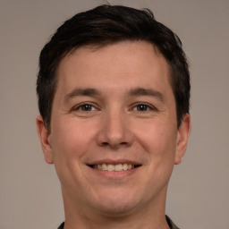 Joyful white young-adult male with short  brown hair and brown eyes